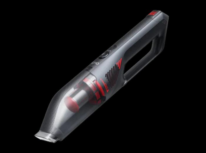 A vacuum cleaner with a black background Description automatically generated