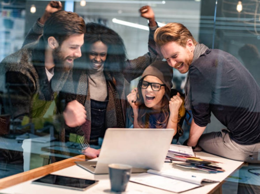 A group of people looking at a computer Description automatically generated